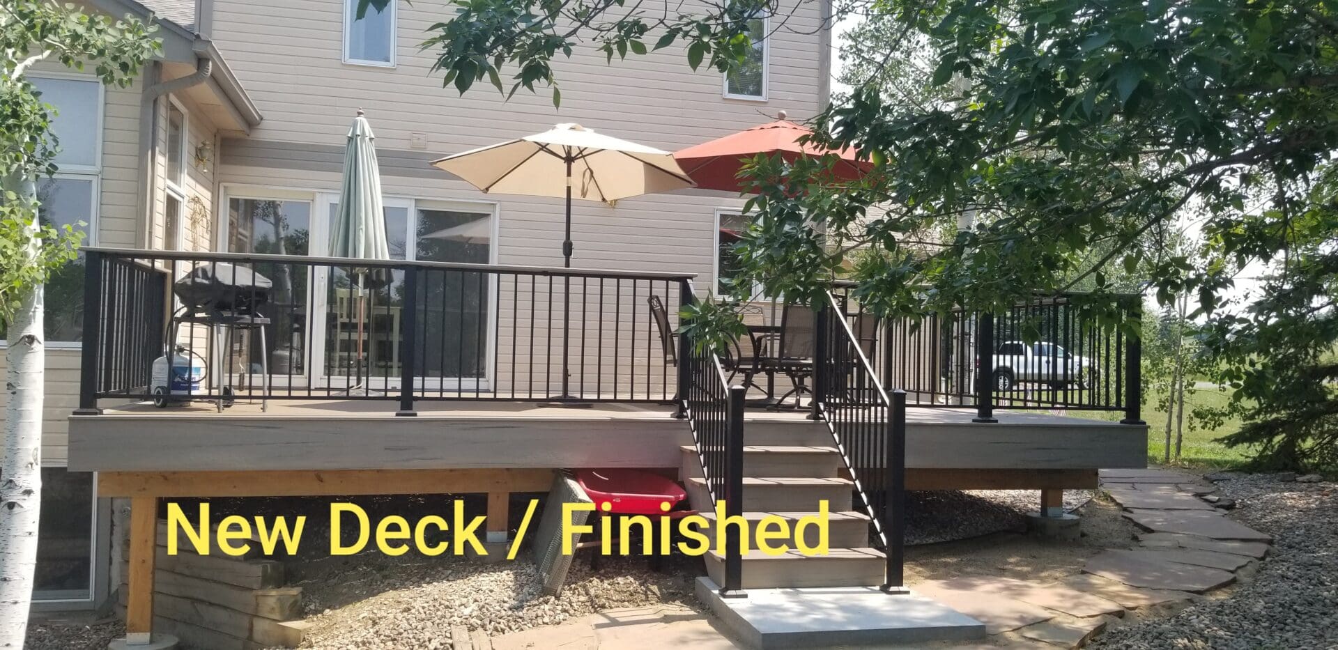 A deck with stairs and steps leading to the top of it.