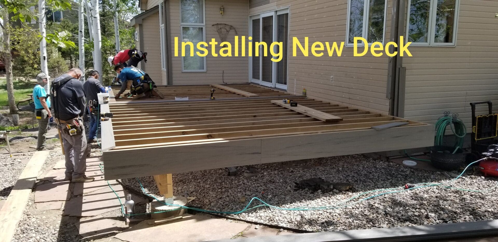 A man working on the deck of his home.