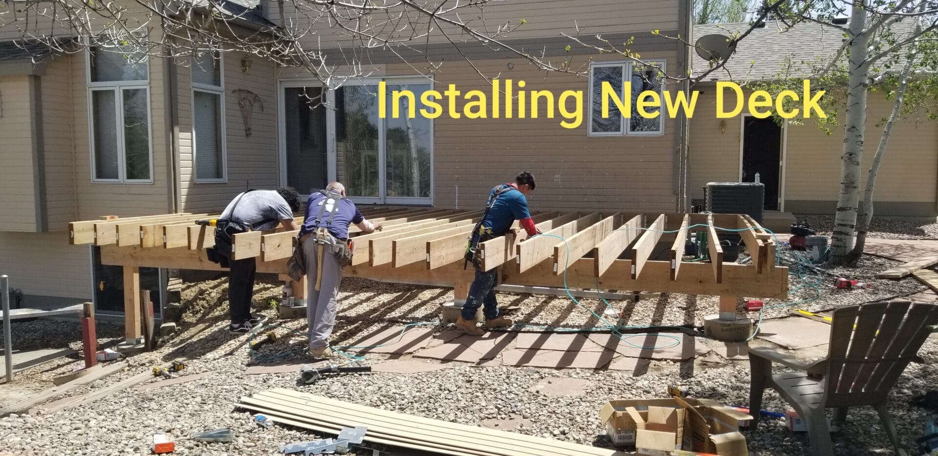 A group of men building wooden benches.