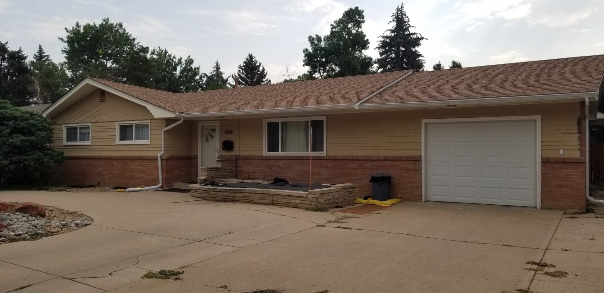 A house with a driveway and garage in front of it.