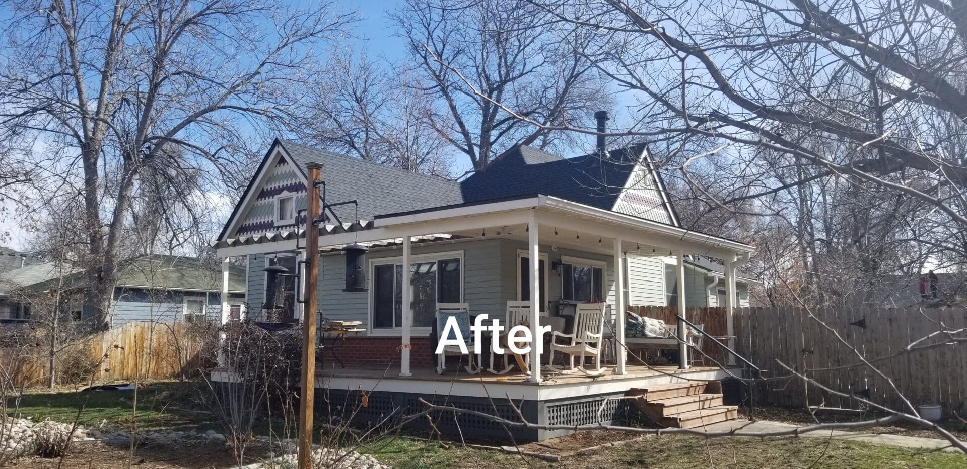 A small house with a porch and a new roof.