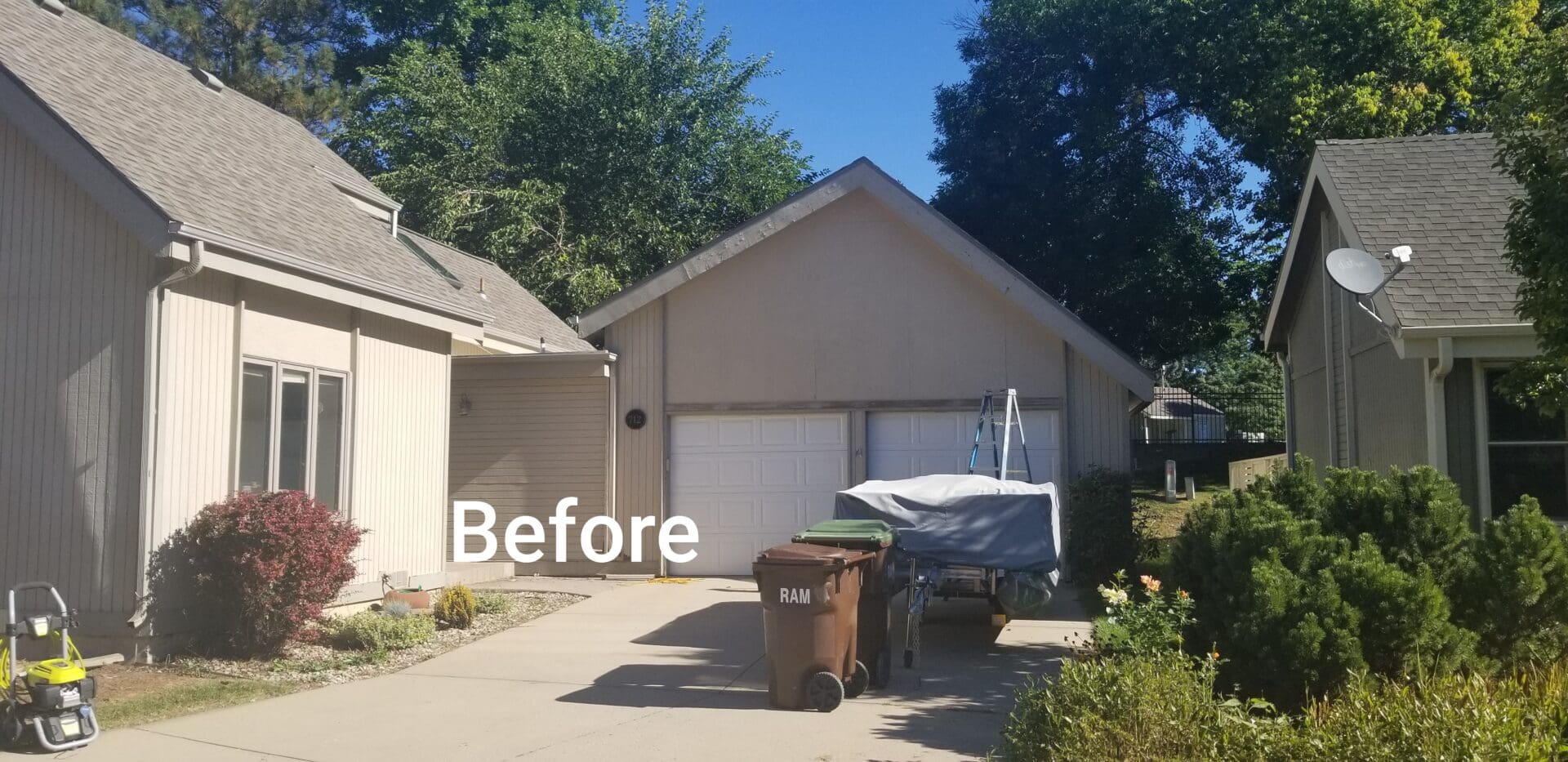 Front of house before painting and new garage doors.