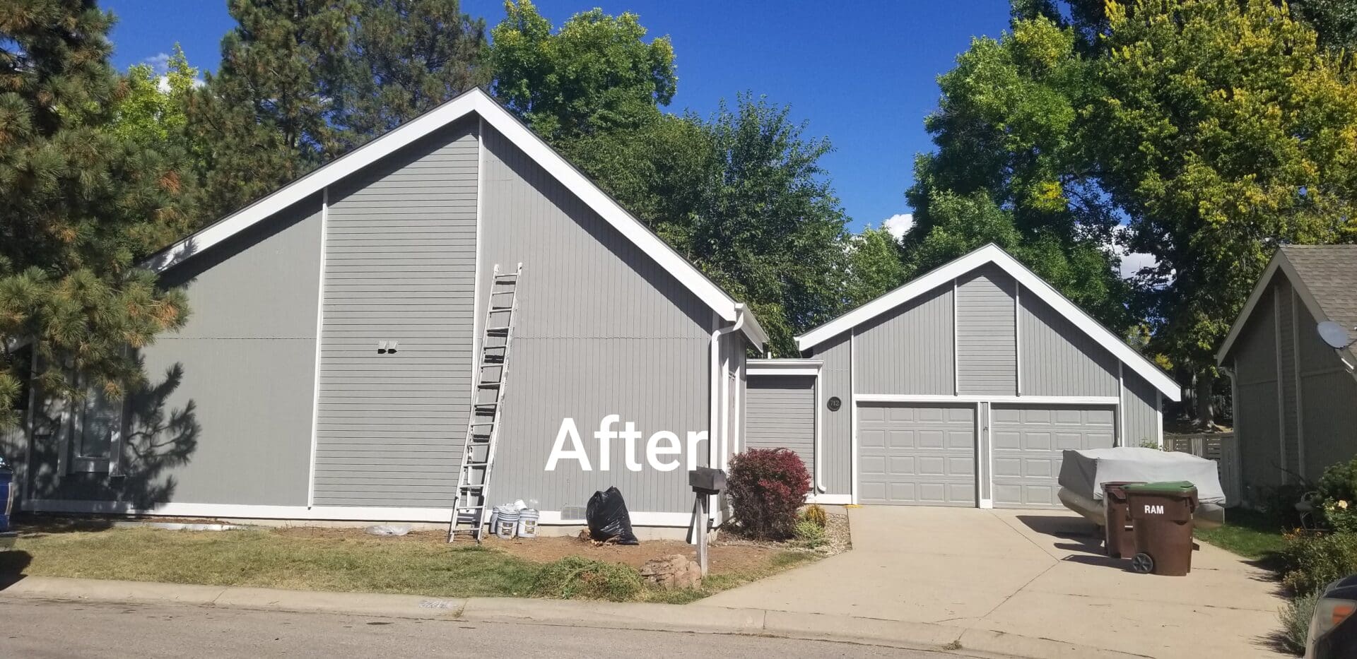 Gray house with white trim and a ladder leaning against it.