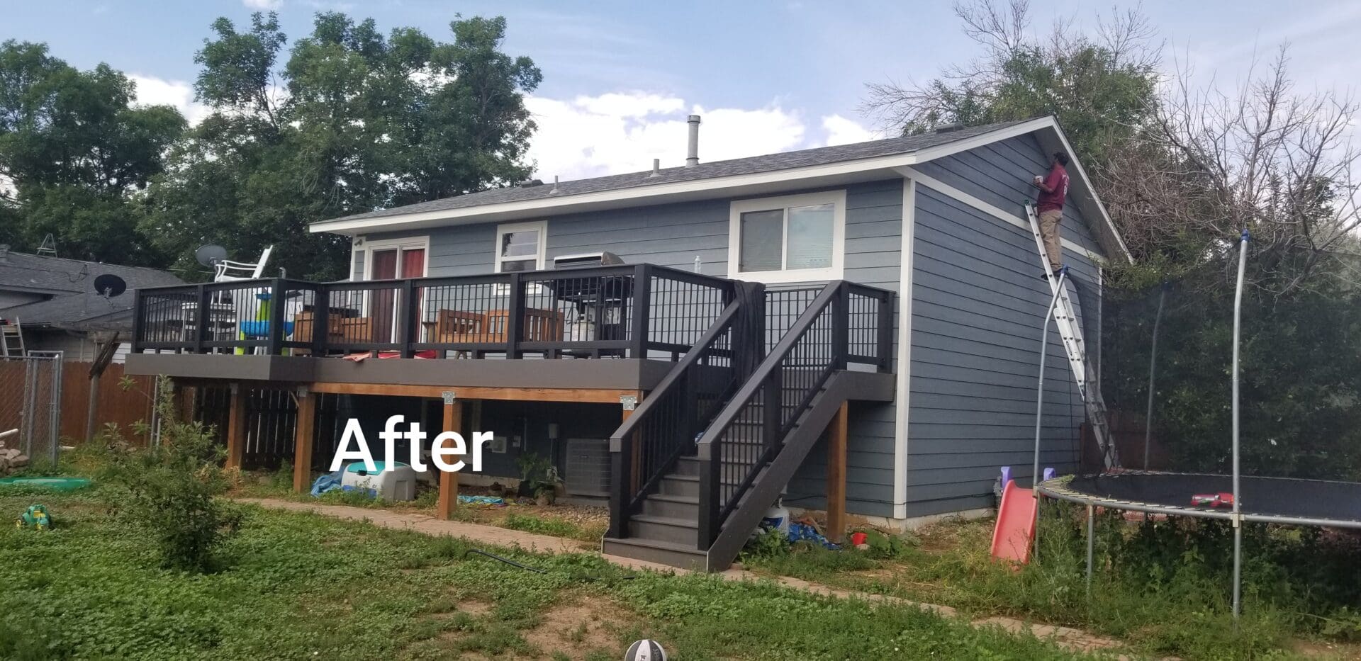 Back of house with new siding and deck.