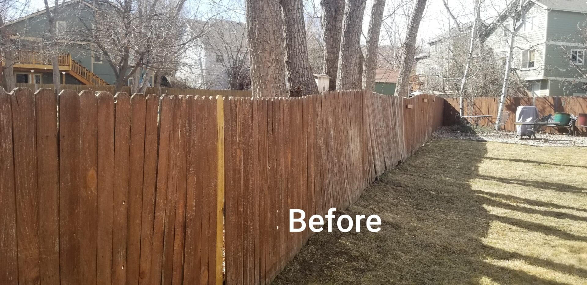 Wooden fence panels in backyard before cleaning.