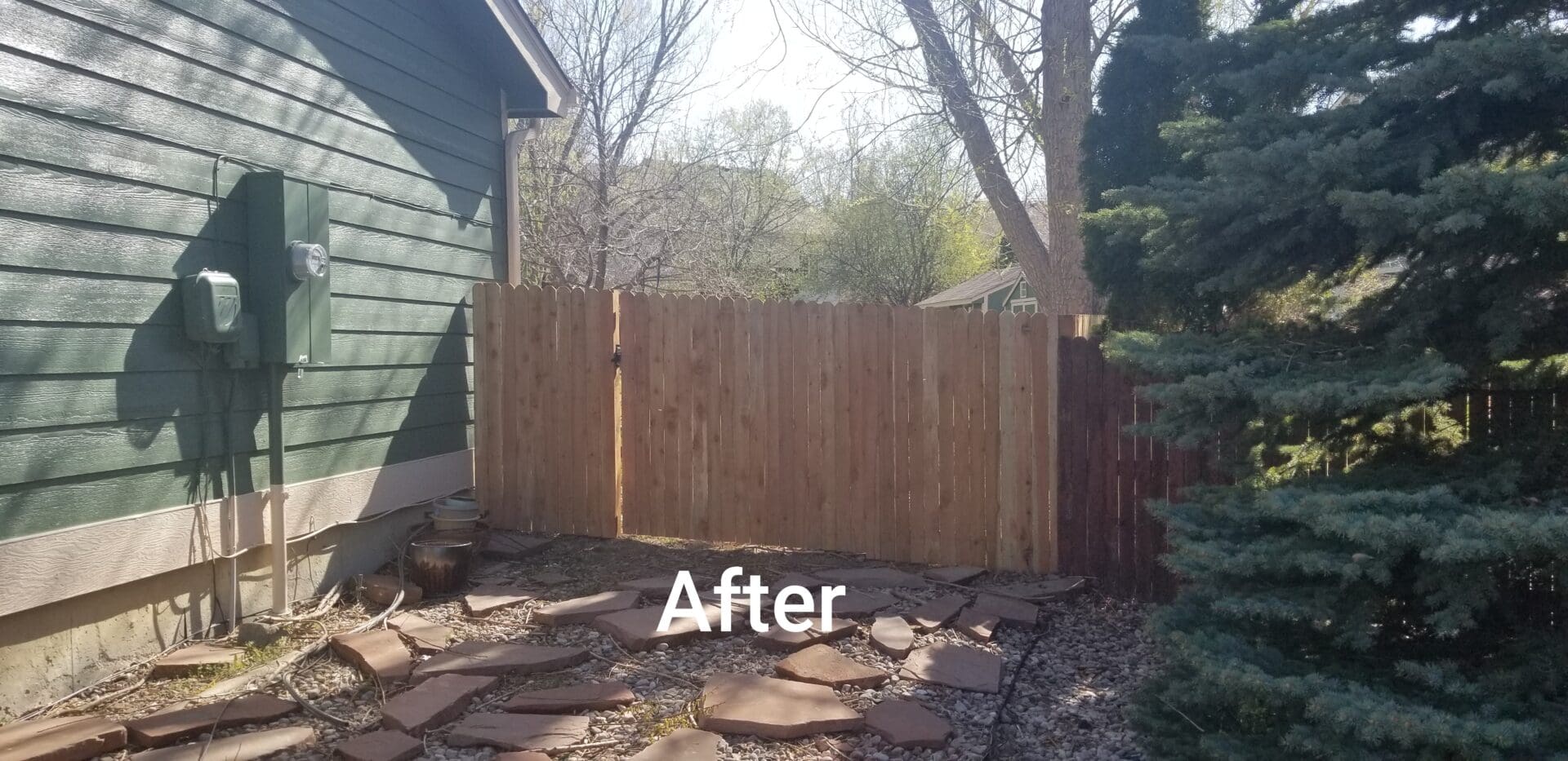 Wooden fence with gate installed in backyard.