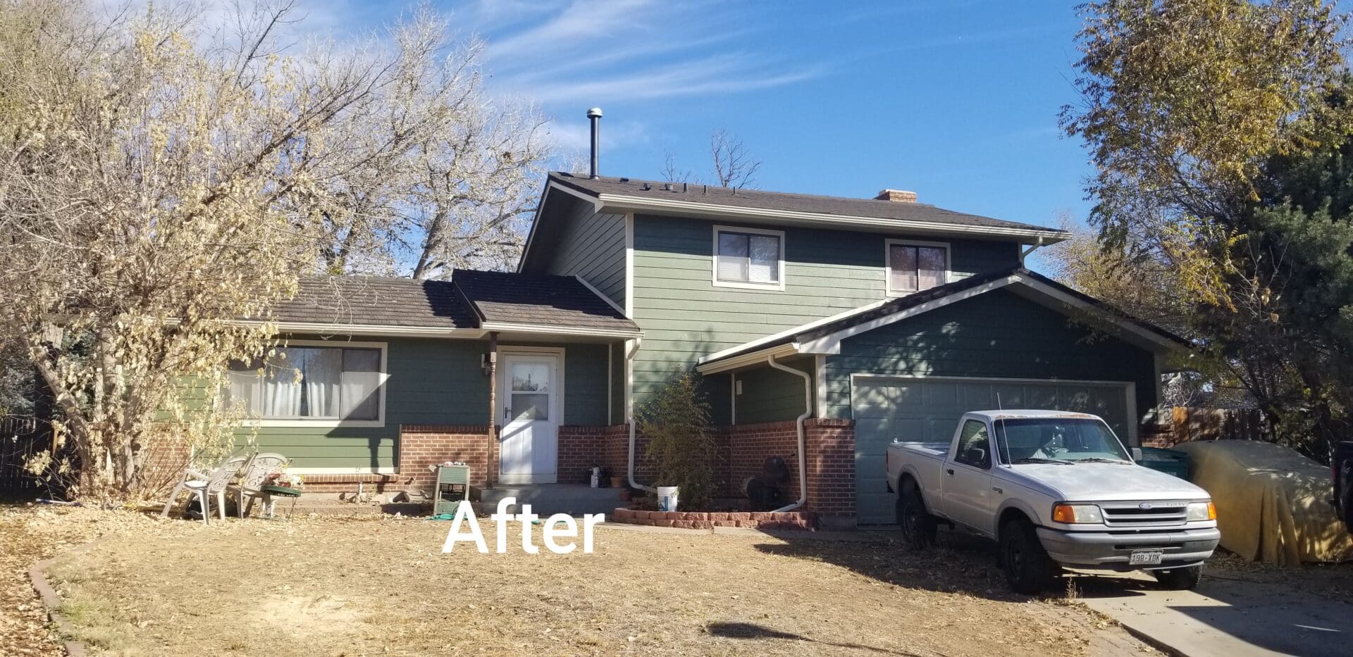 A house with green siding and a gray roof.